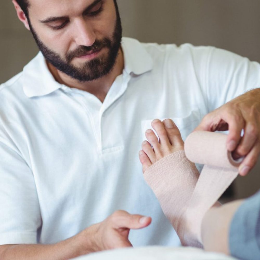 physiotherapist-putting-bandage-on-injured-feet-of-2025-04-03-07-53-23-utc-1-scaled-r9fctf6r9dpszhgckq3hgu4v4hsc4k44ees7qpwf2w